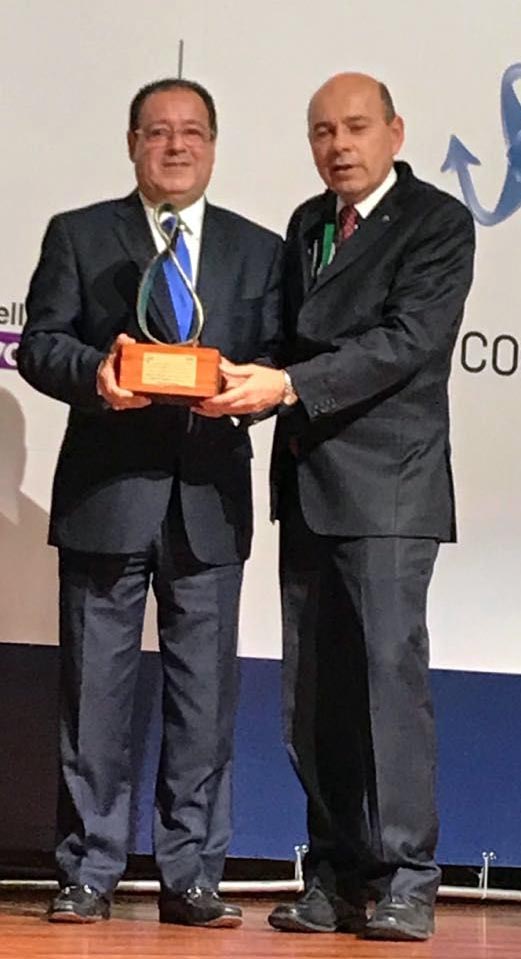El ingeniero Julio César Correa recibe el galardón que le entrega el ingeniero Juan José Carrasco, Director Ejecutivo de la CIER.